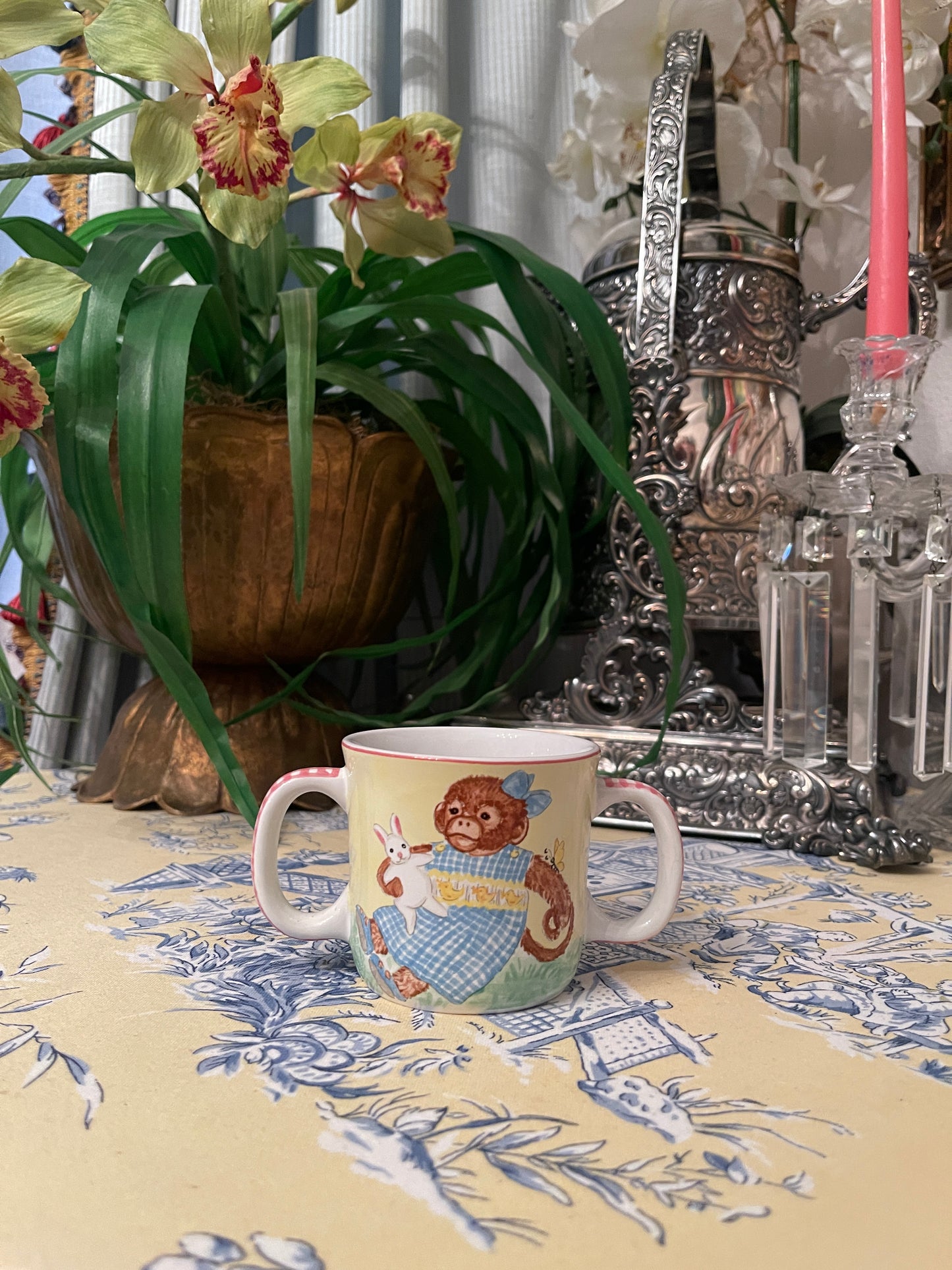 Darling Monkey in a blue and white smocked dress Double Handled Child’s Cup by Kelly B Rightsell, Made in Portugal