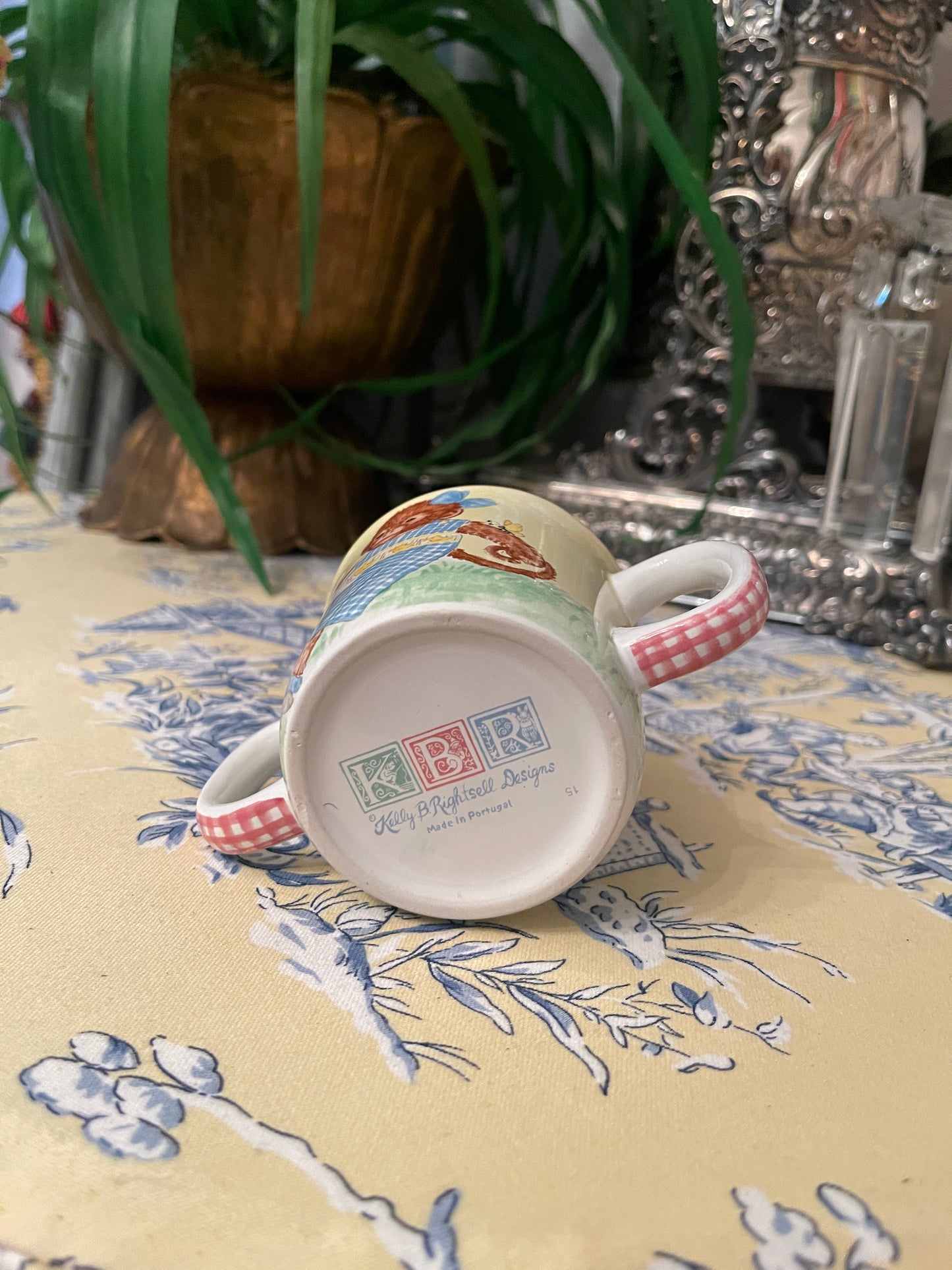 Darling Monkey in a blue and white smocked dress Double Handled Child’s Cup by Kelly B Rightsell, Made in Portugal