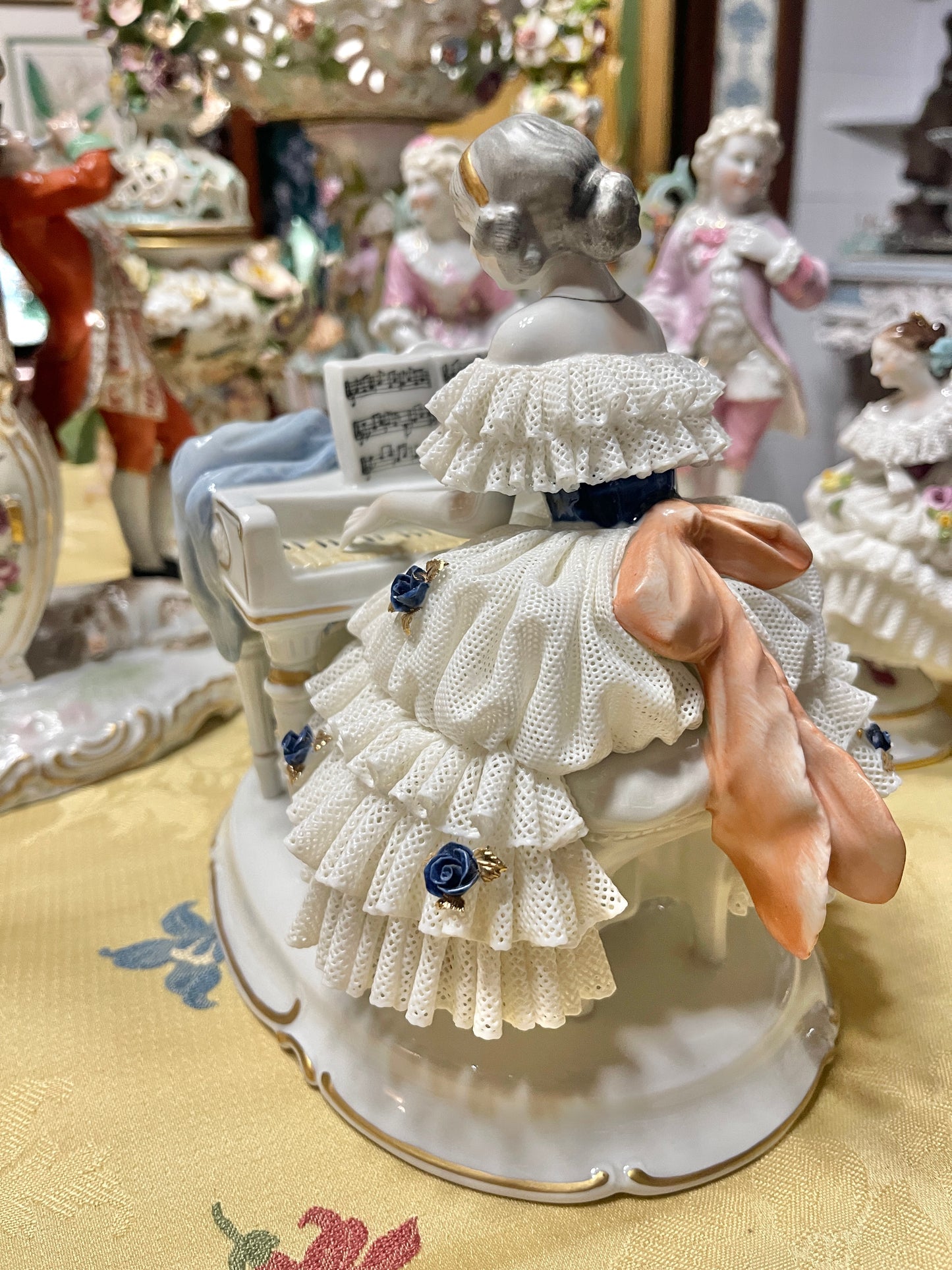 Vintage Royal Dux Bohemia Porcelain Lady at the Piano Figurine, White Porcelain with Blue Applied Roses & Pink Bow — Mid-Century European Figurine